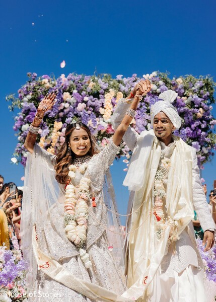 wedding exit moment,purple floral mandap,flower petal toss,just married couple,aisle walk indian wedding