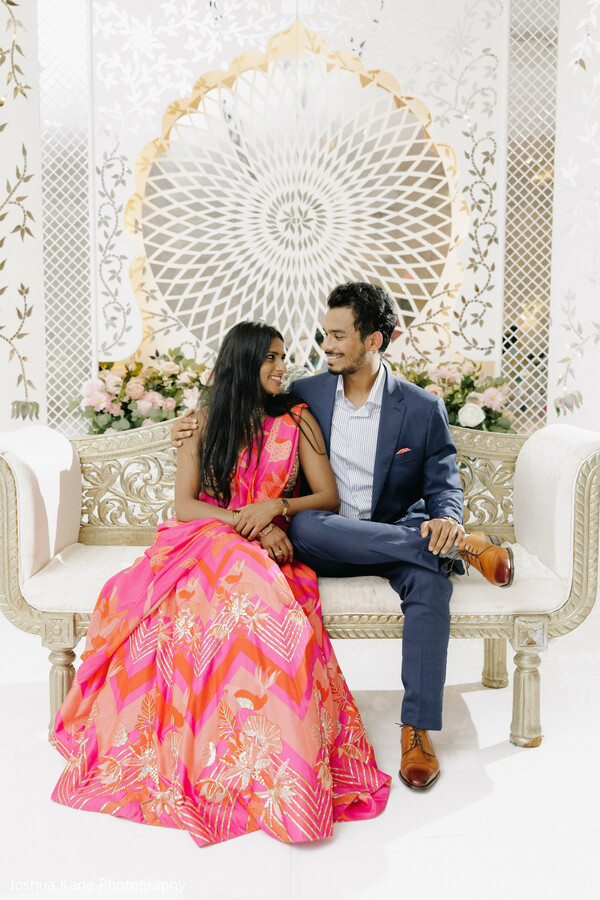 couple seated pose,pink lehenga,navy suit groom,wedding reception photo,modern indian couple