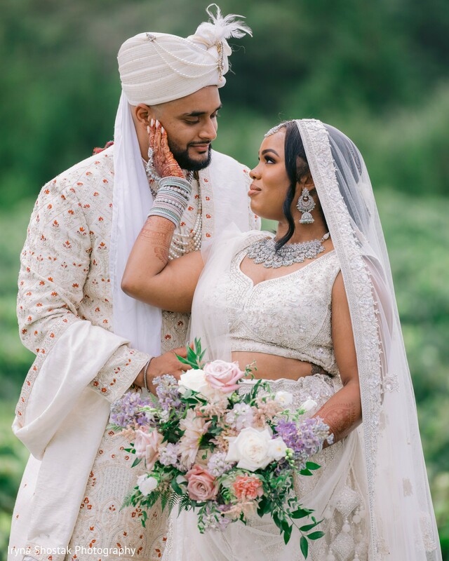 intimate wedding portrait,bride holding groom’s face,romantic vineyard setting,bridal bouquet,pastel floral wedding