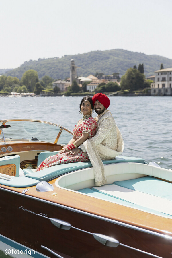 red bridal lehenga,ivory sherwani groom,bridal necklace,couple photography,righi studio portrait