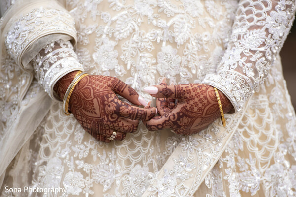 bridal mehndi,henna on hands,lace wedding dress,close-up wedding photo,south asian bride