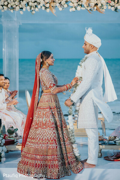 wedding vows,indian wedding,ocean backdrop,beach mandap,bride and groom exchange