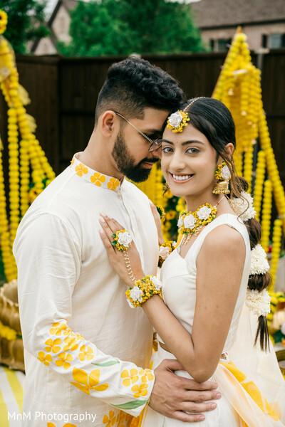 haldi couple portrait,floral haldi outfit,yellow wedding attire,indian pre-wedding shoot