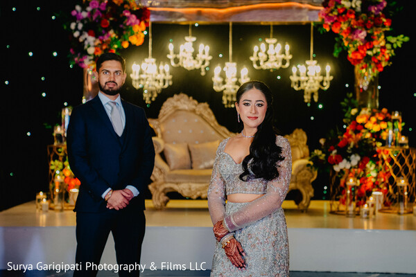 reception decor,chandeliers and florals,south asian couple,formal evening wear,bride in shimmer