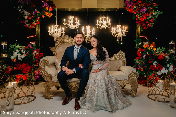 reception sofa,chandeliers and florals,south asian couple,indian wedding glamour