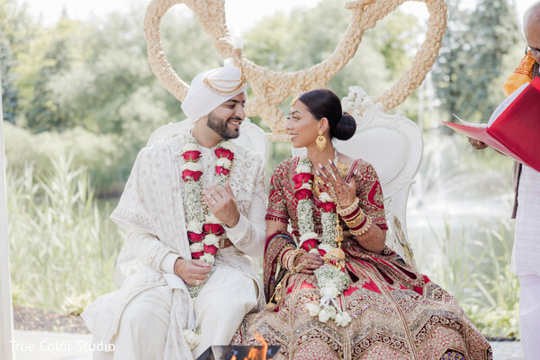 indian wedding mandap,couple smiling during ceremony,joyful wedding moment