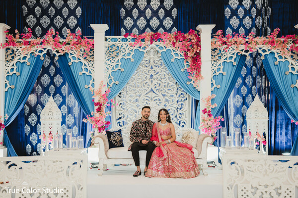 elegant wedding stage,south asian couple portrait,colorful wedding decor,blue and pink wedding theme