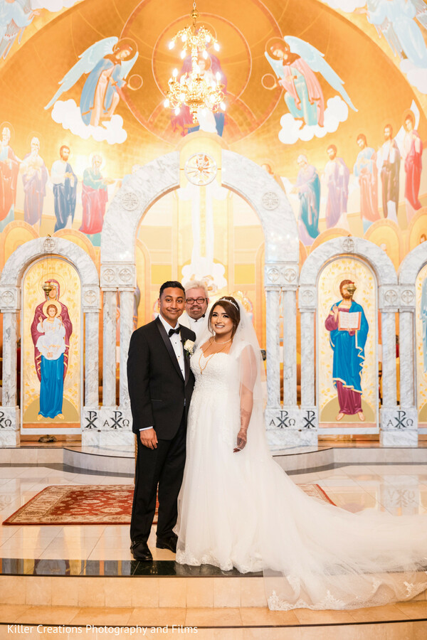 church wedding portrait,orthodox altar,religious mural backdrop,bride and groom,cathedral wedding,gold dome ceiling,flowing bridal train,sacred space,timeless elegance,christian wedding ceremony