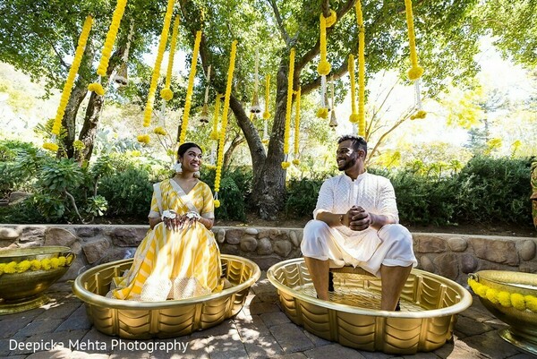 indian forest wedding,couple seated ceremony,natural wedding rituals,yellow haldi setup,woven basket decor,cultural wedding elements,sacred nature moment,indian pre-wedding,traditional indian seating,forest wedding magic