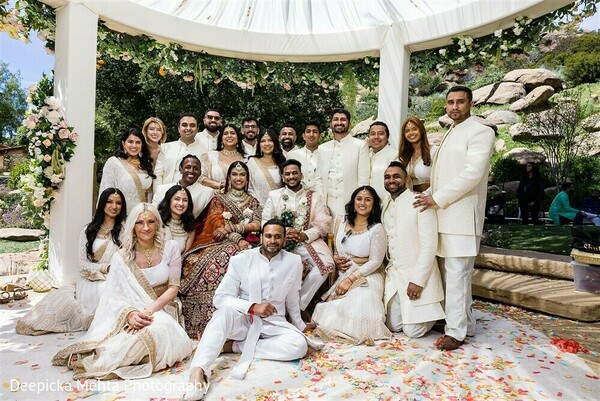 wedding party portrait,bridal party coordination,bridesmaids in ivory,groomsmen in beige,indian wedding crew,group photo mandap backdrop,festive wedding squad,celebration unity,cultural team moment,elegant group style