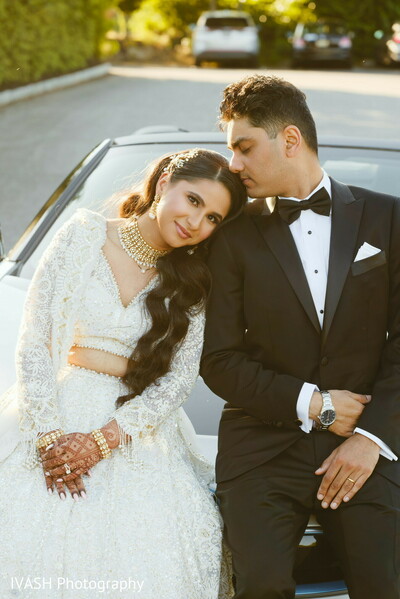 indian couple golden hour,bride groom romance,post-wedding serenity,bride leaning groom,soft light love,black tux white gown,indian modern wedding photo,evening wedding moment,romantic couple pose,bride groom tenderness