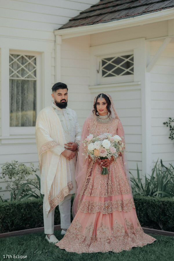 bride and groom photo,bouquet moment,garden wedding,soft pastel tones,floral details,posed wedding portrait