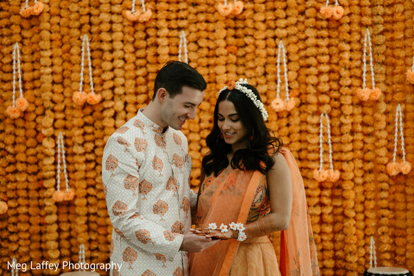 floral wedding backdrop,couple photo,playful wedding portrait,vibrant wedding decor,wedding couple.