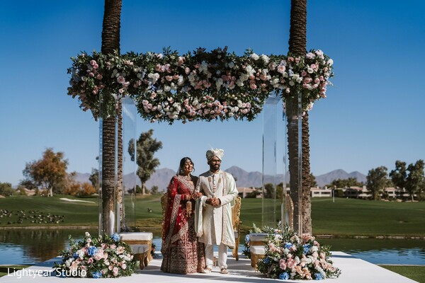floral wedding arch,outdoor ceremony,natural wedding decor,bride and groom vows,wedding altar backdrop,romantic wedding ceremony.