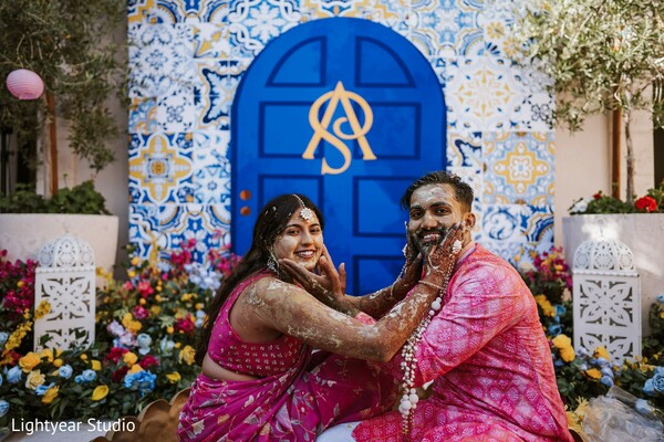 pink wedding attire,blue door background,couple portrait,traditional wedding photography,cultural wedding.