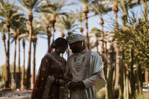 wedding couple,palm trees,romantic photography,outdoor wedding scene,cultural wedding portrait.