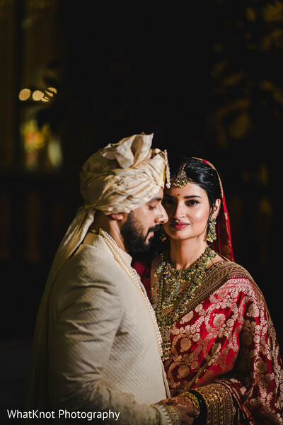 romantic indian couple night,bride groom whispering,soft wedding portrait,low light wedding photo,elegant wedding attire pose,cultural wedding romance,turban groom black background,intimate indian wedding,south asian love story,luxury couple portrait