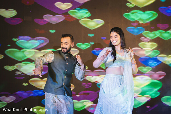 bokeh heart light background,wedding couple fun shot,indian couple dance floor,creative lighting wedding photo,colorful bokeh wedding effect,joyful engagement portrait,romantic wedding party look,couple under mood lighting,playful wedding lighting idea