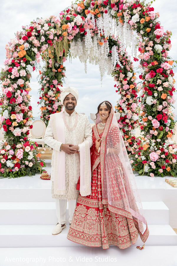 wedding ceremony,floral arch,indian couple,traditional wedding,mandap,bridal lehenga,groom sherwani