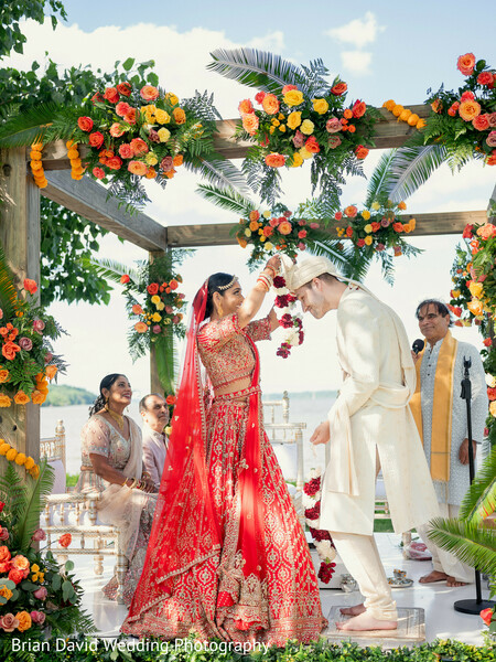hindu wedding,floral mandap,indian wedding ceremony,phere,red bridal attire,sacred fire rituals,outdoor wedding