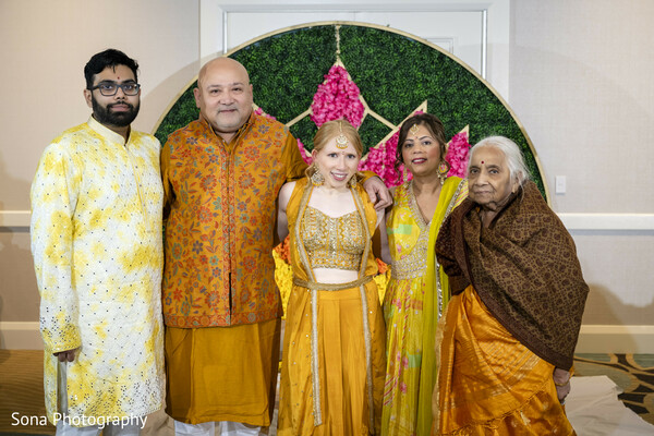 group photo,haldi ceremony,colorful outfits,family gathering,indian wedding rituals,festive attire