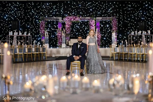 groom kneeling,first dance,reception,candles,confetti,romantic moment,ballroom