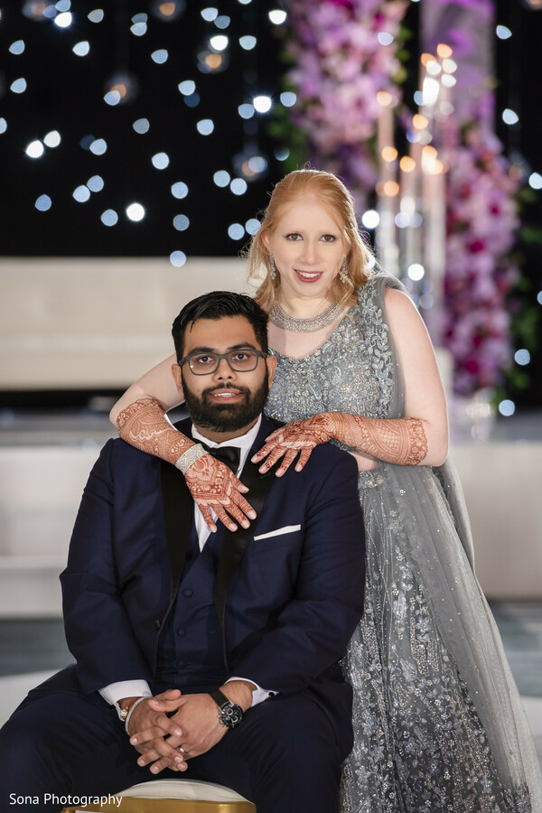 couple portrait,seated pose,reception glam,silver gown,groom in suit,elegant shot
