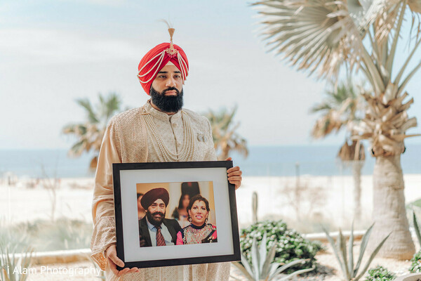 framed photo remembrance,groom tribute,honoring family wedding,emotional wedding moment,sikh groom sentiment,indian wedding photo,groom solo tribute,touching wedding image,legacy and love,memory in frame