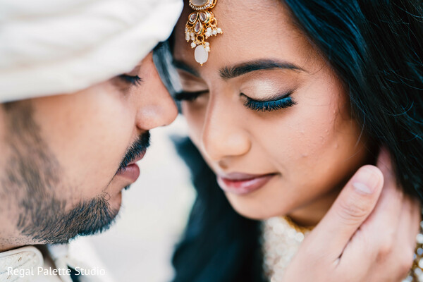 bride groom close-up,intimate wedding portrait,south asian couple love,wedding emotion photo,romantic indian wedding,couple nose touch,deep connection love shot,bridal jewelry detail,romantic moment,wedding tenderness