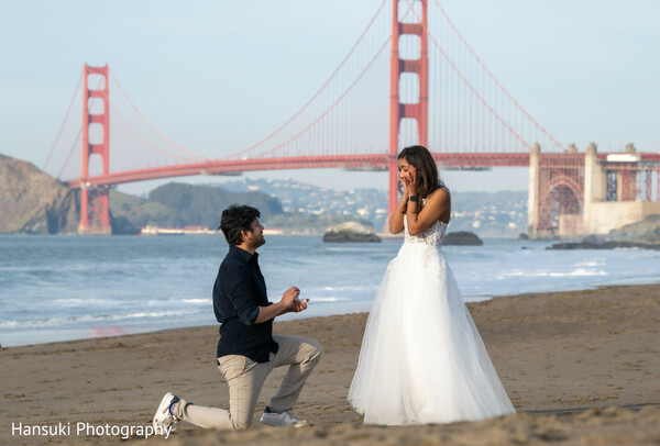 beach wedding walk,couple golden gate background,indian couple beach photo,san francisco love shoot,golden gate bridge romance,hand in hand photo,white dress beach vibe,relaxed love story,iconic sf wedding,walking together