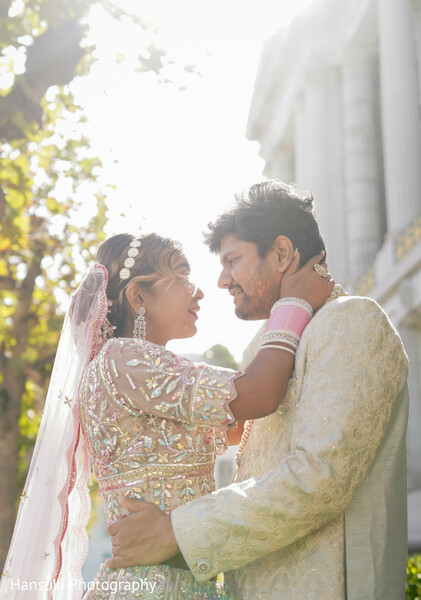 candid couple photo,joyful wedding moment,south asian bride groom laughing,golden light wedding,playful couple portrait,romantic natural light shot,ivory pink wedding attire,sunshine couple hug,love and laughter,indian wedding romance