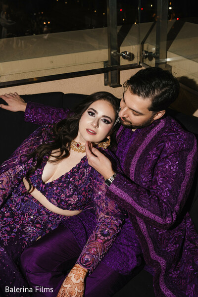 bride and groom style,violet wedding outfits,embroidered lehenga,romantic couple moment,mehndi love,south asian fusion couple,jewel tone fashion,modern wedding glam,indian engagement photo,chic wedding look