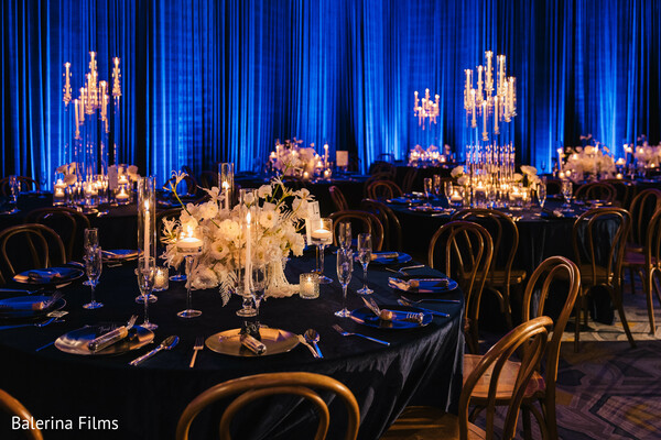 wedding reception decor,royal blue lighting,crystal candelabras,candlelight elegance,luxury wedding setup,black tie wedding,floral centerpieces,moody wedding ambiance,glamorous reception,romantic wedding vibe