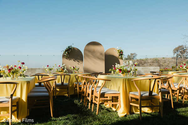 outdoor wedding decor,yellow reception theme,garden wedding inspiration,floral tablescape,bright wedding palette,modern mandap design,south asian wedding style,reception setup,cheerful decor,open-air wedding