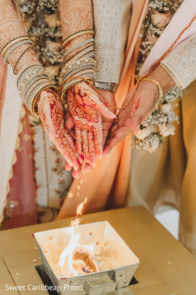 indian wedding rituals,fire ceremony,bride and groom hands,mangalsutra moment,henna close-up,bangles and bracelets,sacred fire,hindu tradition,intimate ritual,cultural symbolism