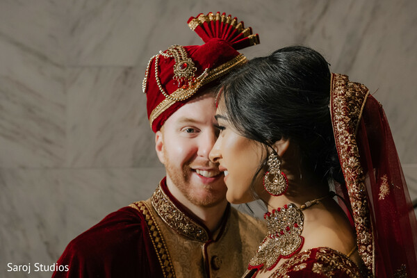 close-up wedding couple,bride and groom romance,maroon wedding attire,indian wedding portrait,bridal earrings,soft bridal moment,groom turban style,intimate wedding photo,love-filled gaze,cultural wedding elegance.