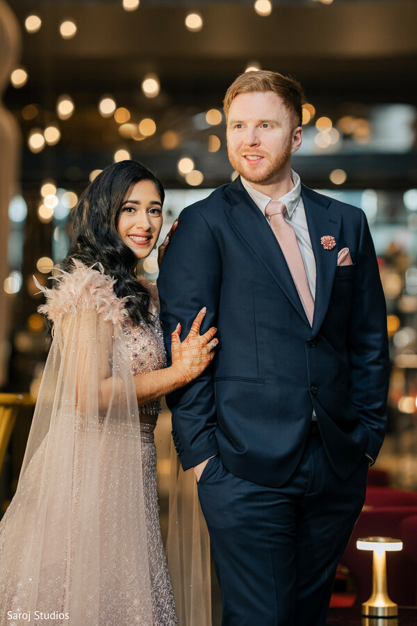 post-wedding couple look,blush bride gown,groom navy suit,reception couple style,soft wedding lighting,modern wedding fashion,joyful newlyweds,elegant evening outfits,contemporary wedding portrait,stylish wedding couple.