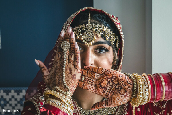 bridal mehndi,creative portrait,eye close-up,red bridal look,henna art,statement jewelry,indian bride style,cultural beauty,romanza photography,glam bride