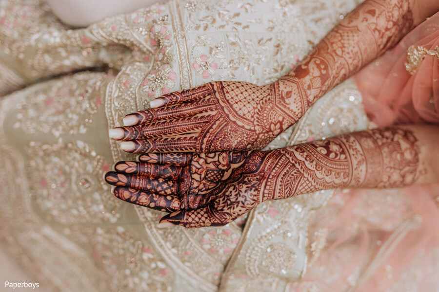 mehndi design,bridal hands,henna art,pastel lehenga,indian wedding,close-up detail,bride prep,wedding rituals,emotional moments,pre-ceremony beauty