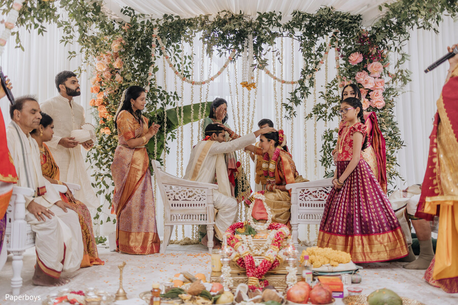 indian wedding ceremony,floral mandap,hindu traditions,sacred vows,colorful attire,wedding rituals,cultural wedding,spiritual moment,south asian wedding,ceremony decor