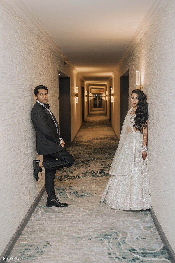 bride and groom hallway,modern wedding,bridal gown,groom tuxedo,anticipation,wedding architecture,dramatic composition,elegant couple,wedding fashion,cinematic moment