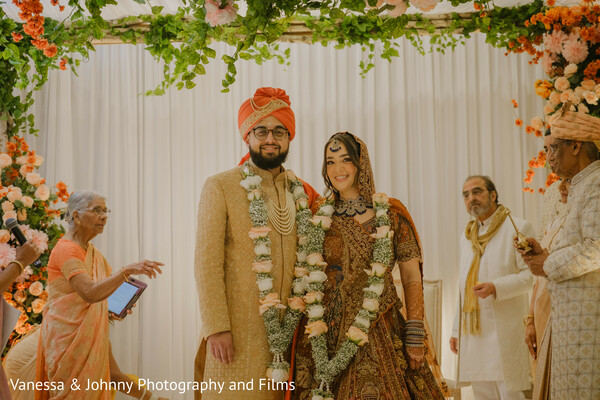 Newlywed Smiles Under a Floral Canopy