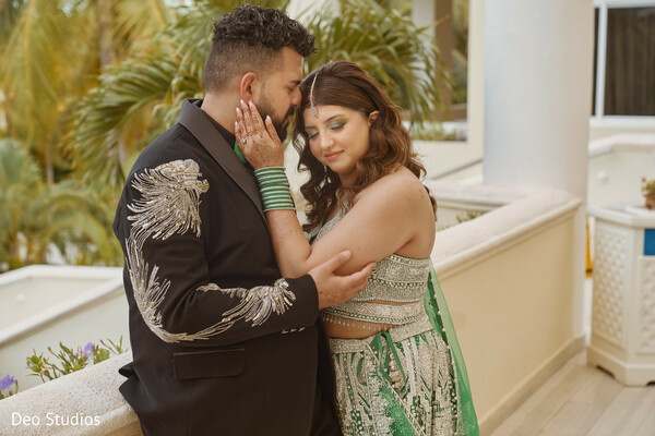 balcony portrait,indian couple,wedding fashion,green lehenga,embroidered tux,intimate moment,luxury wedding,romantic pose,soft light,modern south asian wedding