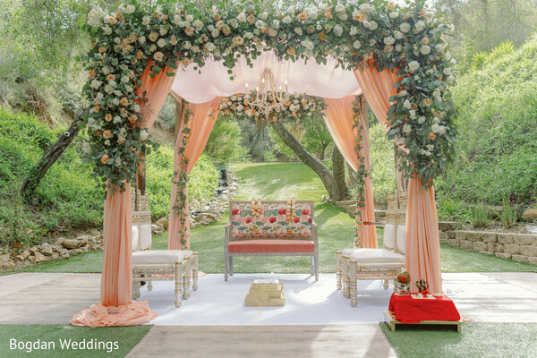 wedding mandap decor,peach floral mandap,outdoor hindu wedding,luxurious ceremony setup,wedding altar inspiration,floral arch mandap,elegant wedding decor,garden wedding scene,nature and love,indian wedding aesthetic