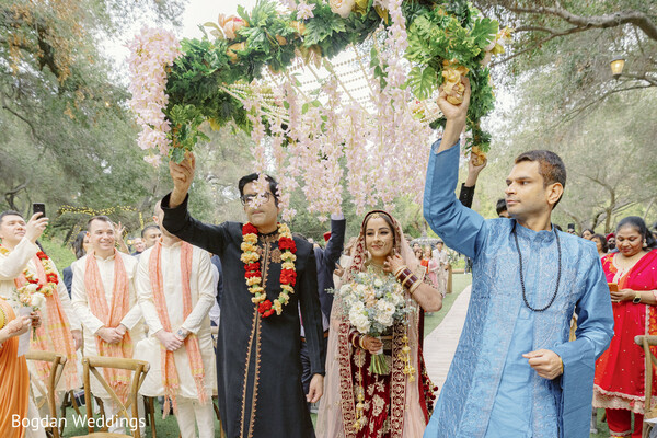phoolon ki chaadar,bride wedding entrance,floral aisle walk,indian bride walking in,wedding procession,joyful bridal moment,red bridal lehenga,wedding flower canopy,indian wedding traditions,bride with bouquet