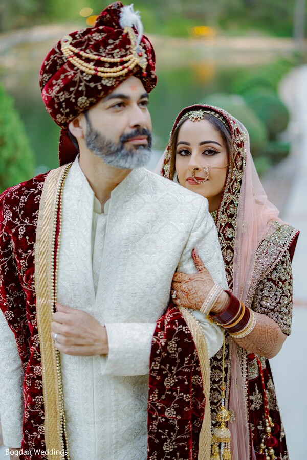 indian groom portrait,bride following groom,red bridal lehenga,ivory sherwani,regal wedding style,traditional indian outfits,bridal dupatta drape,indian wedding couple,groom in turban,elegant wedding entrance