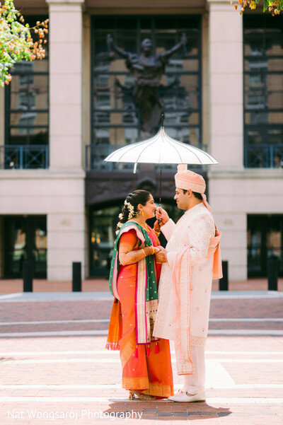 couple urban portrait,indian groom and bride,south asian wedding couple,traditional wedding outfits,outdoor romantic moment,sari and sherwani look,city wedding photo,elegant couple photo,love and architecture,traditional indian wedding attire
