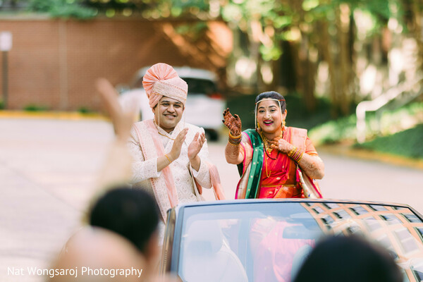 indian wedding departure,vidaii moment,just married car,convertible exit,south asian bride farewell,wedding getaway car,groom and bride wave,modern wedding send-off,happy couple moment,cultural tradition farewell