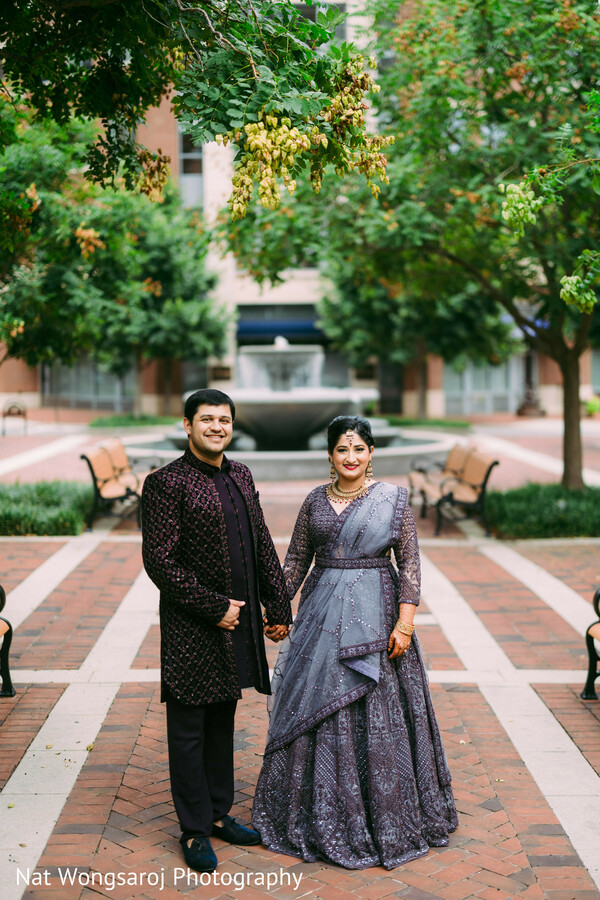 formal wedding shoot,indian wedding couple,evening couple portrait,luxury indian outfits,navy gown bride,groom in charcoal,glam wedding look,south asian fashion moment,romantic evening shoot,urban elegance wedding