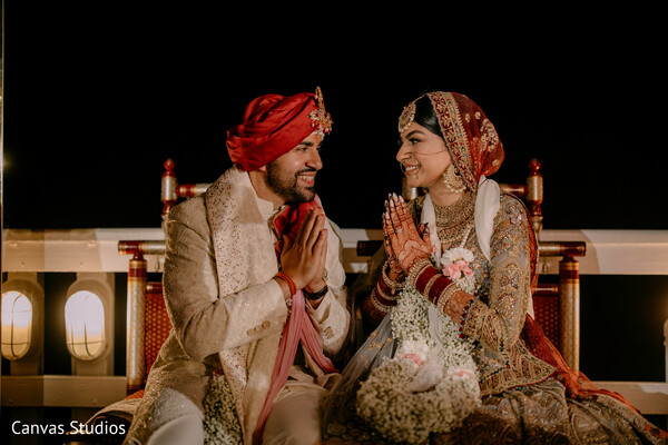 post-ceremony portrait,hindu wedding,sacred fire rituals,red bridal attire,groom turban,nighttime wedding,traditional indian ceremony,spiritual moment,joyful bride,cultural celebration